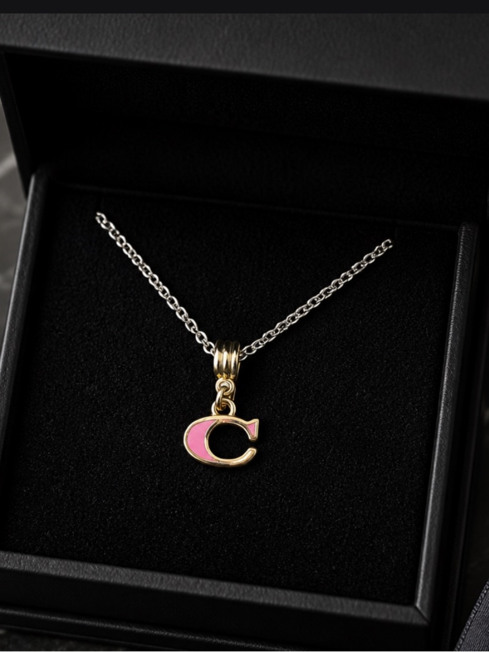 COACH  “C” Pink in color looks beautiful with the dainty silver chain (20”)